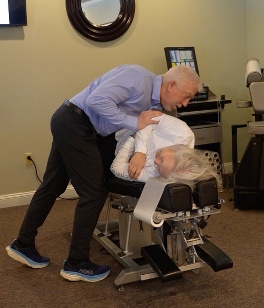 Dr. Mark Arsenault, chiropractor back pain treatment in female patient